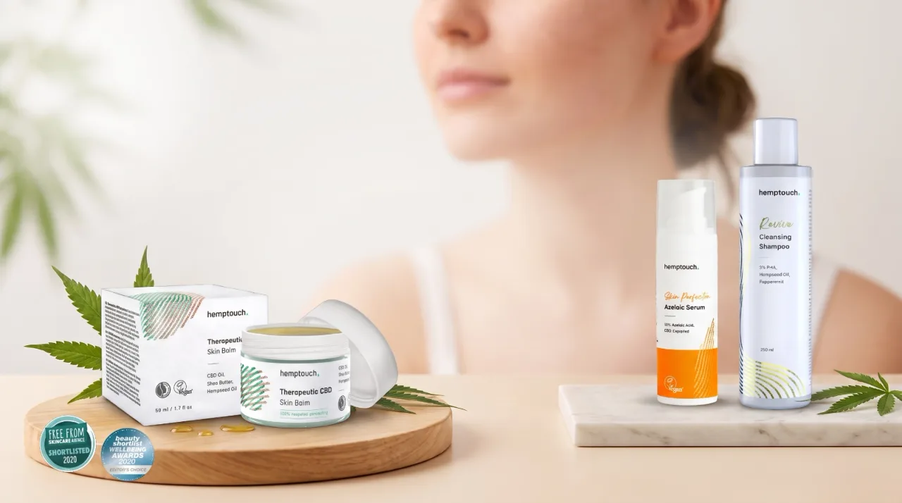 Hanf- und CBD-Hautpflegeprodukte von Hemptouch, darunter Therapeutic CBD Skin Balm, Azelaic Serum und Cleansing Shampoo, dekoriert mit Hanfblättern.